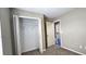 Neutral bedroom features a closet with shelving and a doorway to the bathroom at 519 Sw 19Th Ave, Ocala, FL 34471