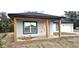 View of the home's front porch, freshly landscaped yard, and driveway leading to a one car garage at 519 Sw 19Th Ave, Ocala, FL 34471