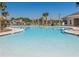 Large freeform community pool with plenty of lounge chairs at 6203 Sw 93Rd Loop, Ocala, FL 34476