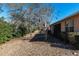 Backyard view of single story house with screened porch and landscaping at 7947 Sw 80Th Place Rd, Ocala, FL 34476