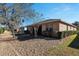 Backyard view of single story house with screened porch and landscaping at 7947 Sw 80Th Place Rd, Ocala, FL 34476