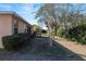 Side yard view of a single story house with a screened porch at 7947 Sw 80Th Place Rd, Ocala, FL 34476