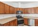 Modern kitchen with stainless steel appliances and wood cabinets at 7947 Sw 80Th Place Rd, Ocala, FL 34476