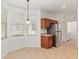 Eat-in kitchen with corner window and wood cabinets at 7947 Sw 80Th Place Rd, Ocala, FL 34476