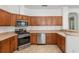 Kitchen with stainless steel appliances and light brown cabinets at 7947 Sw 80Th Place Rd, Ocala, FL 34476