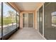 Open screened porch with sliding doors leading to the interior at 7947 Sw 80Th Place Rd, Ocala, FL 34476