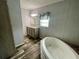 Bathroom featuring a soaking tub, neutral walls, wood-look floors, and a double sink vanity at 11605 Nw 20Th St, Ocala, FL 34482