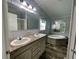 Bathroom featuring dual sinks, a soaking tub, and neutral-colored cabinetry at 11605 Nw 20Th St, Ocala, FL 34482