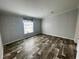 Light-filled bedroom with wood-look floors, fresh paint, and a serene atmosphere at 11605 Nw 20Th St, Ocala, FL 34482