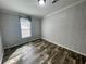 Bedroom featuring wood-look flooring, a window, and neutral wall color at 11605 Nw 20Th St, Ocala, FL 34482