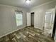 Bedroom featuring wood-look flooring and a window for natural light at 11605 Nw 20Th St, Ocala, FL 34482