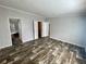 Spacious bedroom featuring wood-look laminate flooring, a closet, and neutral walls at 11605 Nw 20Th St, Ocala, FL 34482