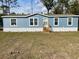 Charming single-story home featuring light blue siding, a white foundation, and a well-kept lawn at 11605 Nw 20Th St, Ocala, FL 34482