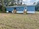 Charming blue manufactured home featuring two separate entrances, each with a small wooden porch at 11605 Nw 20Th St, Ocala, FL 34482