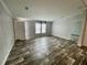 Bright living room with modern wood-look floors, fresh paint, and plenty of natural light at 11605 Nw 20Th St, Ocala, FL 34482