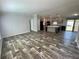 Spacious living room featuring modern wood-look floors flowing into an open floorplan at 11605 Nw 20Th St, Ocala, FL 34482