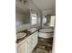 Bathroom with double vanity, soaking tub, and wood-look flooring at 11625 Nw 20Th St, Ocala, FL 34482