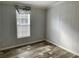 Well-lit bedroom featuring wood-look floors and window coverings at 11625 Nw 20Th St, Ocala, FL 34482