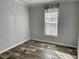 Spacious bedroom with wood-look floors and a window with blinds at 11625 Nw 20Th St, Ocala, FL 34482