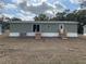 Rear view of manufactured home with two sets of stairs and AC unit at 11625 Nw 20Th St, Ocala, FL 34482