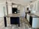 Modern kitchen with large island, white cabinets, and granite countertops at 11625 Nw 20Th St, Ocala, FL 34482