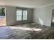 Bright living room with wood-look floors and large windows at 11645 Nw 20Th St, Ocala, FL 34482