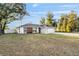 Charming single-story home featuring modern color accents, attached garage, and a spacious front yard at 13573 Sw 115 Pl, Dunnellon, FL 34432