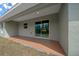 Covered back patio with sliding glass doors and a terracotta-colored floor at 8436 Sw 136Th Ter, Dunnellon, FL 34432