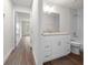 Small bathroom with granite countertop, white cabinet, and bathtub at 8436 Sw 136Th Ter, Dunnellon, FL 34432