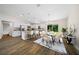 Kitchen and dining area with white cabinets and hardwood floors at 8436 Sw 136Th Ter, Dunnellon, FL 34432