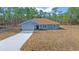 New construction home featuring a light blue exterior and a large yard at 8436 Sw 136Th Ter, Dunnellon, FL 34432