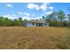 Back of house with sliding doors and expansive lawn at 8436 Sw 136Th Ter, Dunnellon, FL 34432