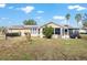 Exterior view of backyard featuring a lawn and solar panels at 8968 Sw 116Th Place Rd, Ocala, FL 34481