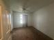 Bedroom with a ceiling fan and large window showing the bright exterior at 8968 Sw 116Th Place Rd, Ocala, FL 34481