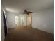 Spacious bedroom with neutral carpet, ceiling fan, and multiple doorways at 8968 Sw 116Th Place Rd, Ocala, FL 34481