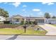 House exterior featuring a well-maintained lawn at 8968 Sw 116Th Place Rd, Ocala, FL 34481