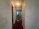 Clean hallway with hardwood floors leading to bedrooms at 8968 Sw 116Th Place Rd, Ocala, FL 34481