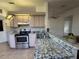 Kitchen featuring stainless steel appliances, light wood cabinets, and ample counter space at 8968 Sw 116Th Place Rd, Ocala, FL 34481