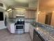 Stainless steel appliances and light colored cabinets in kitchen at 8968 Sw 116Th Place Rd, Ocala, FL 34481