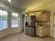 Bright kitchen with stainless steel appliances, and a door leading to outside at 8968 Sw 116Th Place Rd, Ocala, FL 34481