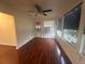 Bright living room with hardwood floors, ceiling fan, with a door leading to the backyard at 8968 Sw 116Th Place Rd, Ocala, FL 34481