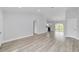 Open floor plan showcasing the living room flowing into the kitchen area, accentuated by modern light-colored flooring at 13559 Sw 115 Pl, Dunnellon, FL 34432