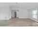 Inviting living room with view to a bathroom. Note the vaulted ceiling, recessed lights, and attractive flooring at 13559 Sw 115 Pl, Dunnellon, FL 34432