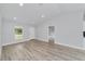 Well-lit living room with a large window, offering great views and highlighting the stylish light-colored flooring at 13559 Sw 115 Pl, Dunnellon, FL 34432