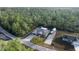 House nestled in a wooded area with a large yard and a detached shed at 21 Fisher Trail Pass, Ocklawaha, FL 32179