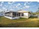 Spacious backyard with a large screened enclosure at 21 Fisher Trail Pass, Ocklawaha, FL 32179