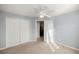 Light-filled bedroom with double doors and closet at 21 Fisher Trail Pass, Ocklawaha, FL 32179