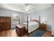 Bedroom with wood furniture and ceiling fan at 21 Fisher Trail Pass, Ocklawaha, FL 32179