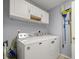 Laundry room with washer, dryer, and cabinets at 21 Fisher Trail Pass, Ocklawaha, FL 32179