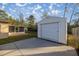 White storage building with a roll-up door at 21 Fisher Trail Pass, Ocklawaha, FL 32179